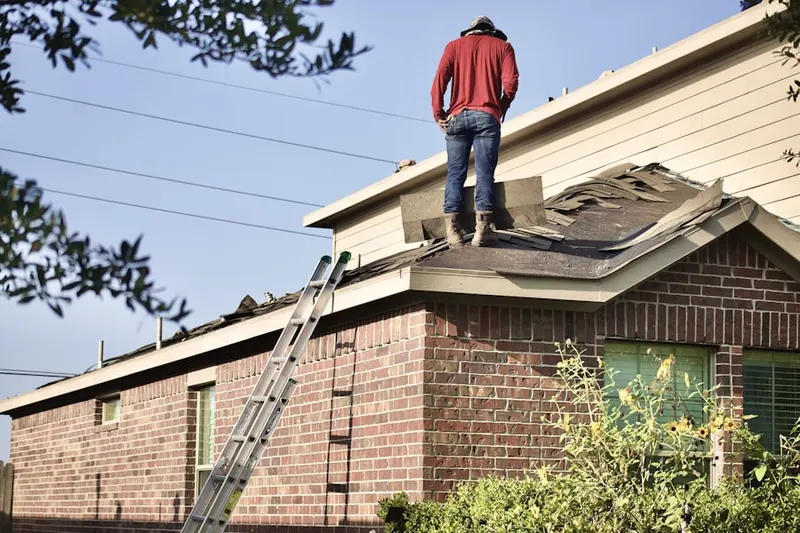 Professional roofer working on a residential roof in Turf Valley Overlook